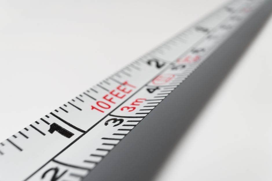 Image of a person measuring their foot with a ruler